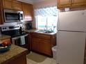 Galley kitchen with granite countertops at 562 Longwood Dr, Venice, FL 34285