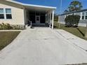 Spacious driveway leads to a covered parking area, adjacent to the lovely home at 590 Portside Dr, North Port, FL 34287