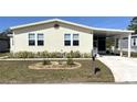 Attractive home featuring a well-kept lawn and a covered parking area at 590 Portside Dr, North Port, FL 34287