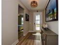 Bright entryway with hardwood floors, and view of bedroom at 600 Nasturtium Ct, Nokomis, FL 34275