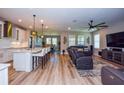 Open concept living room and kitchen with hardwood floors at 600 Nasturtium Ct, Nokomis, FL 34275