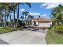 Attractive exterior featuring a tile roof, attached garage, and a neatly landscaped yard at 612 Cadiz Rd, Venice, FL 34285