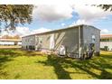 Exterior of home showcasing the siding, windows, and well-kept lawn at 6462 Haele Ct, North Port, FL 34287