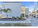 Exterior shot of a coastal condo with parking and tropical landscaping at 700 Golden Beach Blvd # 221, Venice, FL 34285