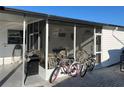 Relaxing screened lanai perfect for outdoor dining, with BBQ, bikes, and comfortable seating at 718 Roma Rd, Venice, FL 34285