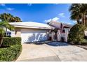 Inviting front exterior features a two-car garage, driveway, and well-maintained landscaping at 734 Brightside Crescent Dr # 18, Venice, FL 34293