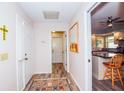 Hallway with wood-look floors leads to the kitchen and other areas of the home at 734 Brightside Crescent Dr # 18, Venice, FL 34293