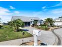 A beautiful single-Gathering home with an attached garage, well-maintained lawn, and lush landscaping at 734 Sugarwood Way, Venice, FL 34292