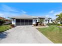 Close up of a home's large attached garage, well-manicured lawn, and a beautiful walkway at 734 Sugarwood Way, Venice, FL 34292