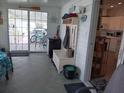 View of the living room with tile floors, a coat rack, and door with a patio view at 749 N Green Cir, Venice, FL 34285