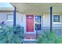 Inviting front entrance with decorative tile and lush landscaping at 7903 Hyde Park Ave, North Port, FL 34287