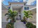 Inviting condo entrance featuring vibrant landscaping, walkway, and well-maintained stairs to the units at 805 Montrose Dr # 203, Venice, FL 34293