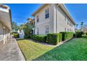 Exterior of the property showcasing the lawn, windows, hedges, and landscaping at 9204 L Pavia Blvd # 9204, Venice, FL 34292