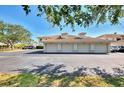 View of the detached garages showing several doors and a parking lot at the front of the building at 9204 L Pavia Blvd # 9204, Venice, FL 34292