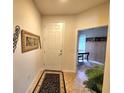 Welcoming foyer with tile flooring, decorative art, and a view into another room at 13892 Alafaya St, Venice, FL 34293