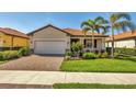 Charming single Gathering home with a well manicured lawn, paver driveway, and a tile roof at 10181 Colubrina Dr, Venice, FL 34293