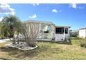 Exterior side view featuring mature landscaping, privacy features, and a well maintained lawn at 105 Lakeview Dr, North Port, FL 34287