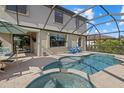 Wonderful screened-in pool area featuring a spa and comfortable seating, perfect for relaxation at 12279 Canavese Ln, Venice, FL 34293