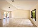 Bright living room with tile floors, large windows, and plenty of natural light at 12321 Alta Mira St, North Port, FL 34287