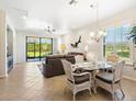 Bright living room with tile flooring, sliding glass doors, and a comfortable seating area at 1342 Maseno Dr, Venice, FL 34292