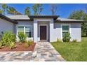 Charming home featuring a decorative front door and colorful landscaping at 1449 Overhead St, North Port, FL 34288
