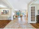 Inviting entryway with tile flooring that transitions to wood, offering a glimpse into the open living space at 1545 Maseno Dr, Venice, FL 34292