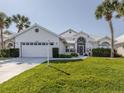 Inviting single-story home with lush green lawn and a two-car garage at 1572 Jasper Ct, Venice, FL 34292