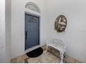 Inviting front entry featuring a blue door and decorative wall art at 1572 Jasper Ct, Venice, FL 34292