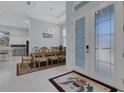Elegant dining area with a large table, stylish chandelier, and open access to the kitchen at 1596 Landfall Dr, Nokomis, FL 34275