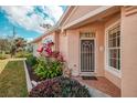 Charming front entrance featuring a decorative door, tiled walkway and colorful garden bed at 1723 San Silvestro Dr, Venice, FL 34285