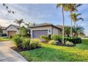 Attractive home with a tile roof, attached garage, and appealing landscaping at 19249 Isadora St, Venice, FL 34293