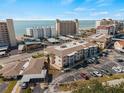 An aerial view showcases the building's architecture with nearby beachfront and convenient parking at 200 The Esplanade N # B10, Venice, FL 34285