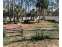 Spacious backyard bordered by a white fence, offering a private and serene outdoor retreat at 2863 Twinkle Ave, North Port, FL 34286