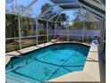 Screened-in pool area with a refreshing blue pool, perfect for relaxing and entertaining at 2863 Twinkle Ave, North Port, FL 34286