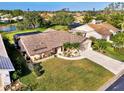 Beautiful aerial view of the home, highlighting the lush landscaping and proximity to a serene lake at 3203 Meadow Run Dr, Venice, FL 34293