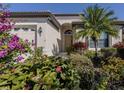 Inviting home featuring manicured landscaping, arched entry, and a cozy front entrance at 4238 Mackay Falls Ter, Sarasota, FL 34243
