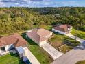An aerial view of a single-story home with lush green trees in the background at 4332 Big Leaf St, North Port, FL 34286
