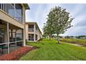 Exterior view of a townhouse with screened patios and views of the surrounding area at 4425 Corso Venetia Blvd # A20, Venice, FL 34293