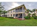 Beautiful exterior view with screened patio and lush greenery and lawn surrounding the townhouse at 4425 Corso Venetia Blvd # A20, Venice, FL 34293