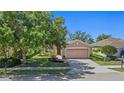 Charming single-story home with a well-manicured lawn, mature trees, and a two-car garage in a desirable neighborhood at 5194 Layton Dr, Venice, FL 34293