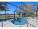 Inviting screened pool area overlooking a serene lake, perfect for relaxation and outdoor enjoyment at 5194 Layton Dr, Venice, FL 34293