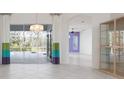 Bright living room with tile floors, stylish lighting, and sliding doors leading to the pool at 707 Petrel Way, Venice, FL 34285