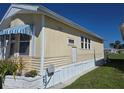 Cozy single-story home featuring light yellow siding and pristine white trim at 88 Bainbridge Dr # 88, Nokomis, FL 34275