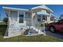 Well-maintained single-story home with a small front porch and white picket fence at 88 Bainbridge Dr # 88, Nokomis, FL 34275