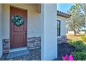 Charming entryway featuring a decorative wreath and stone accents at 351 Carlino Dr, Nokomis, FL 34275