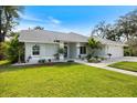 Beautiful single-story home with well-kept lawn, garden beds, and a side-entry garage, offering both style and convenience at 1358 Ewing St, Nokomis, FL 34275