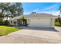 Attractive single-story home showcasing a spacious two-car garage and meticulously maintained landscaping for curb appeal at 1358 Ewing St, Nokomis, FL 34275