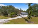 Attractive single-story home featuring a three-car garage and a long, private driveway lined with mature trees at 2537 Northway Dr, Venice, FL 34292