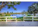 Scenic view of the serene lake from the property's backyard with white railing at 3 Inlets Blvd # 3, Nokomis, FL 34275