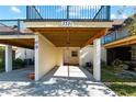 View of the carport featuring a numbered building and under balcony storage at 3351 Ramblewood Ct # 3351, Sarasota, FL 34237